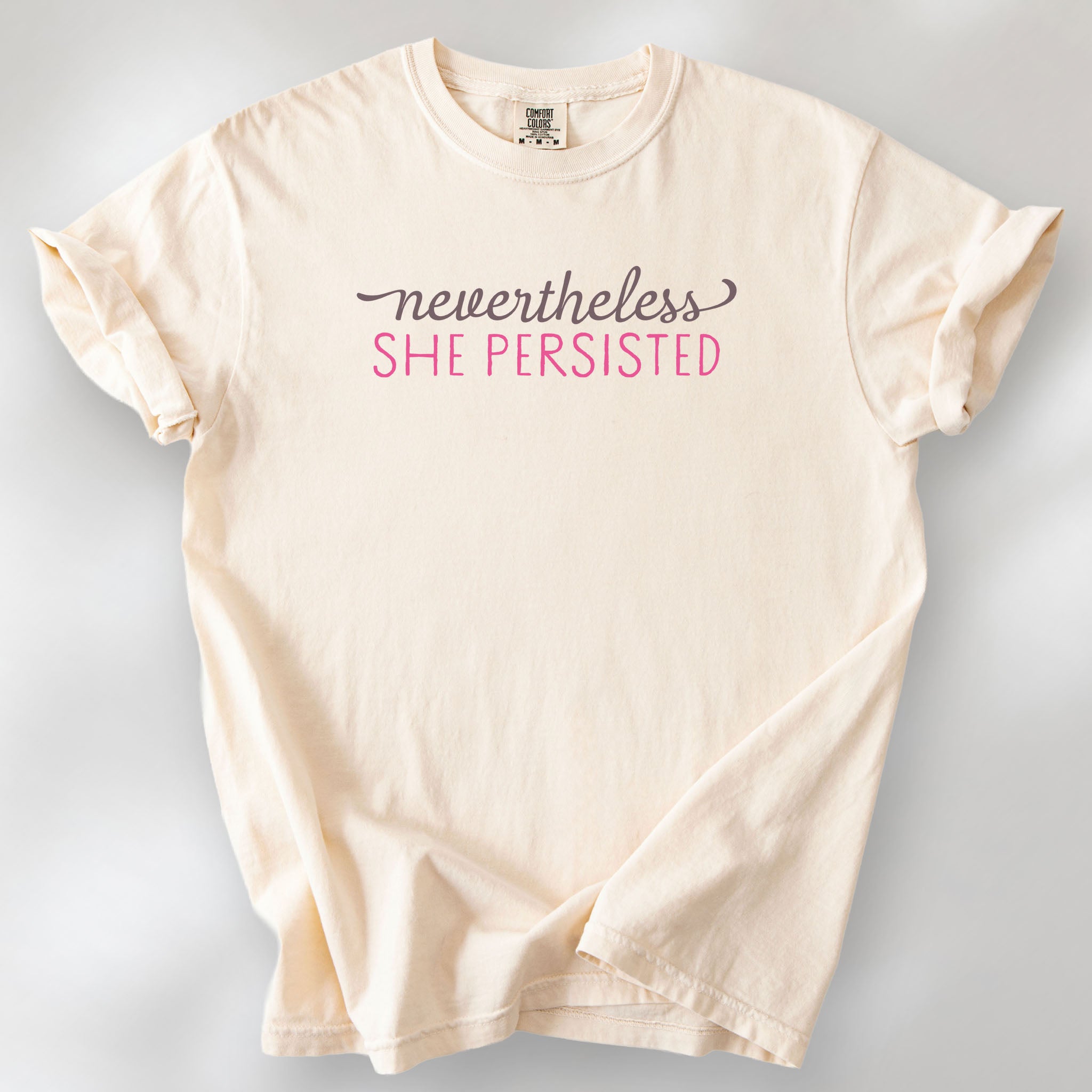 Ivory t-shirt with stylized text that reads "nevertheless she persisted."