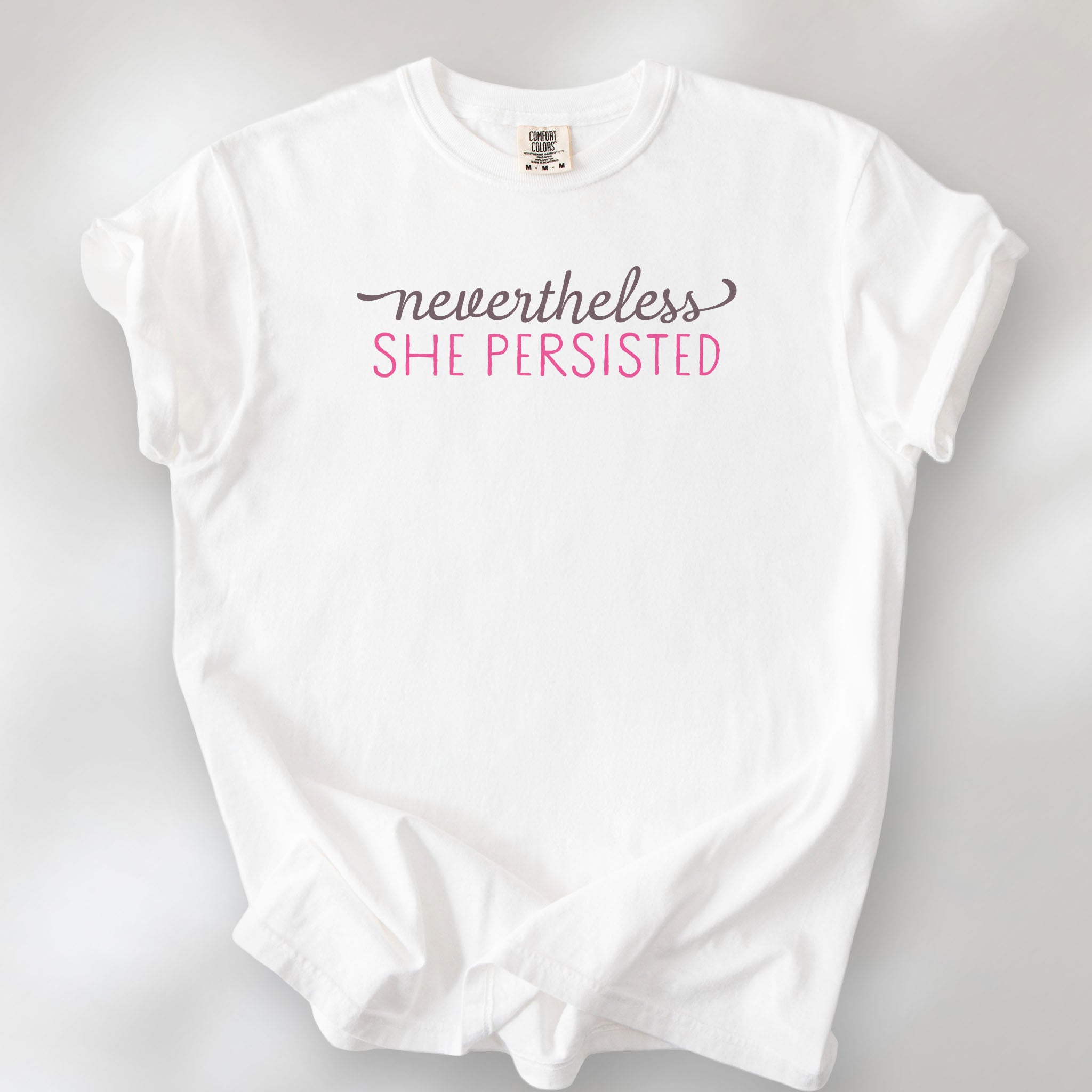White t-shirt with stylized text that reads "nevertheless she persisted."