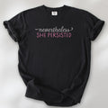 Black Comfort Colors garment-dyed tee with stylized text graphic that reads "nevertheless she persisted."