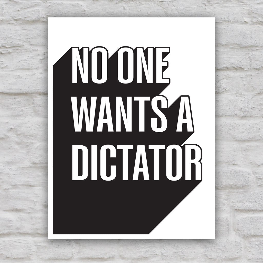 Black and white version of protest sign with bold text reading “No One Wants a Dictator” in white letters with black shadow.