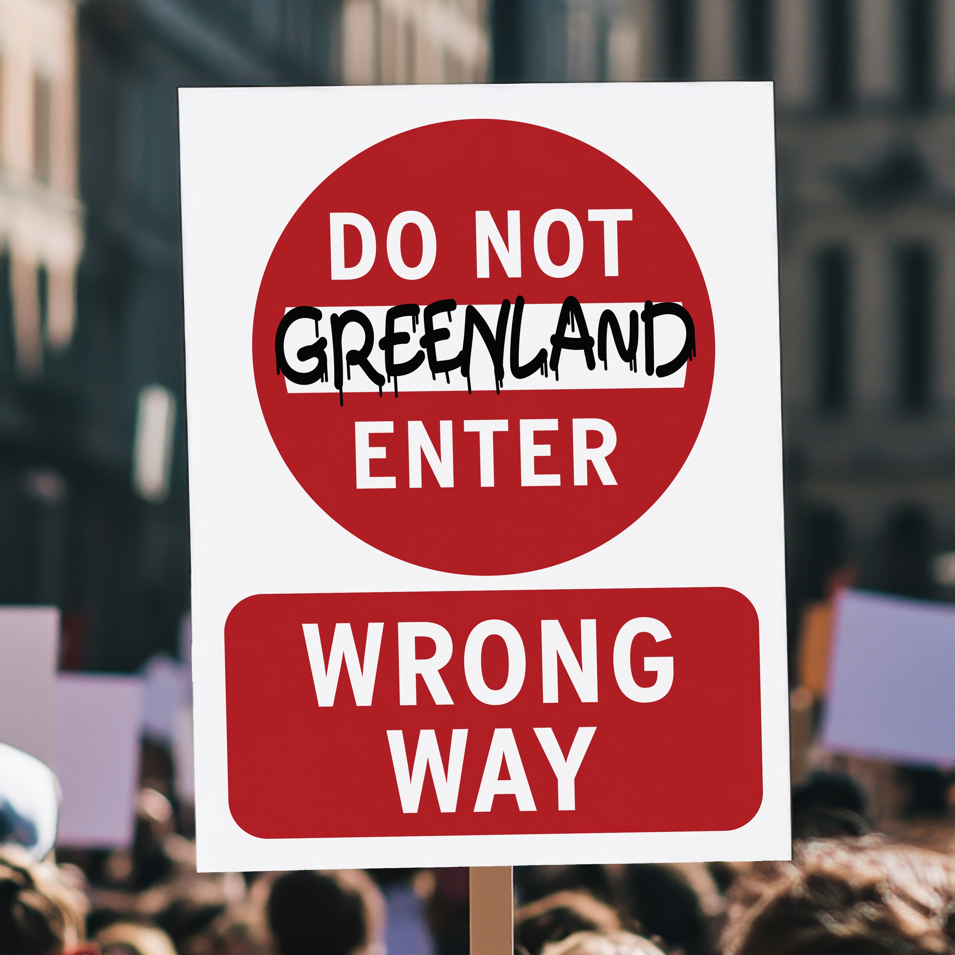Protest sign reading “Do Not Enter Greenland” in bold text like a traffic sign, criticizing Trump’s foreign policy threats and U.S. imperialism, held high in a crowd.
