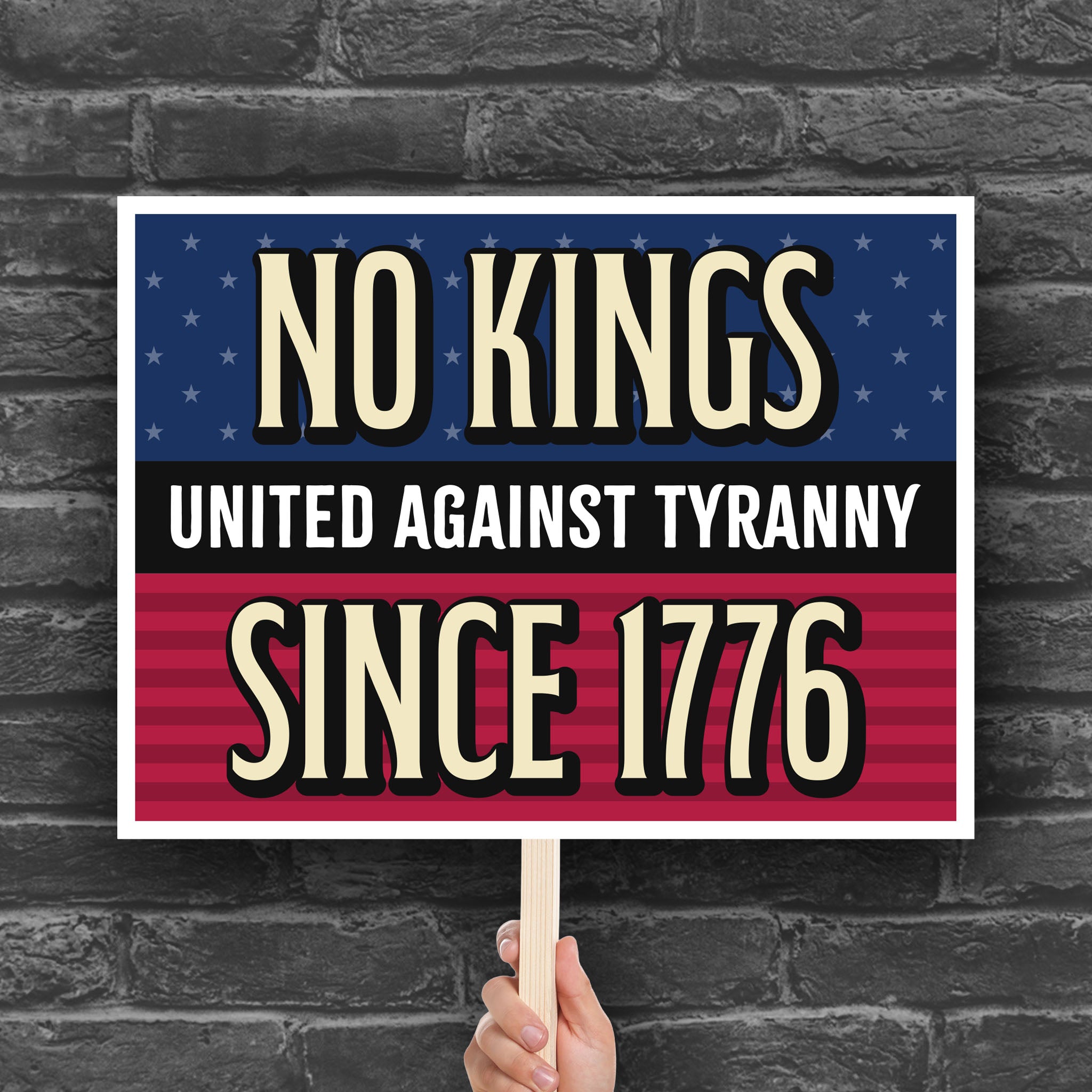 Bold protest sign with blue and red stars and stripes background and gold and white text reading "No Kings – United Against Tyranny – Since 1776" – a defiant, anti-Trump message rejecting authoritarianism and honoring America's revolutionary roots.