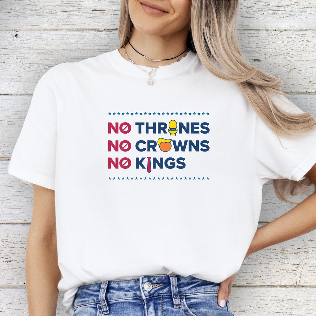 Female model wearing white t-shirt with bold text reading “No Thrones No Crowns No Kings” featuring satirical Trump graphics: gold toilet, yellow hair, and long red tie, original anti-Trump protest shirt.