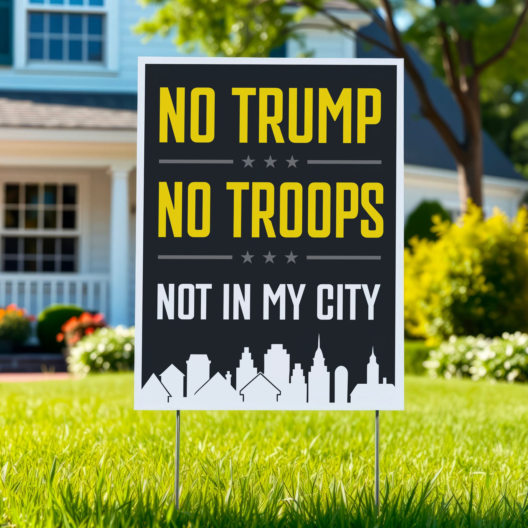 Yard sign sign with bold yellow and white text reading “No Trump No Troops Not in My City” over a dark background with a city skyline silhouette, planted in green lawn.