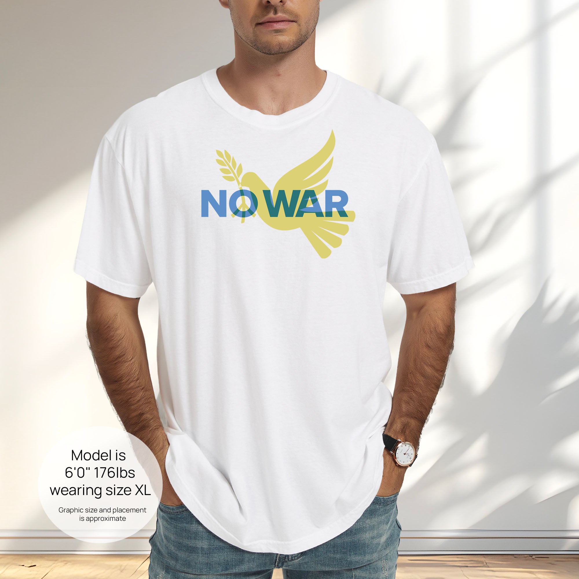 Male model wearing white t-shirt featuring blue “No War” text over a yellow peace dove carrying an olive branch that forks into a peace sign over the text. Includes size and fit information for the model who is 6 feet 0 inches, 176 pounds, and wearing a size XL shirt.
