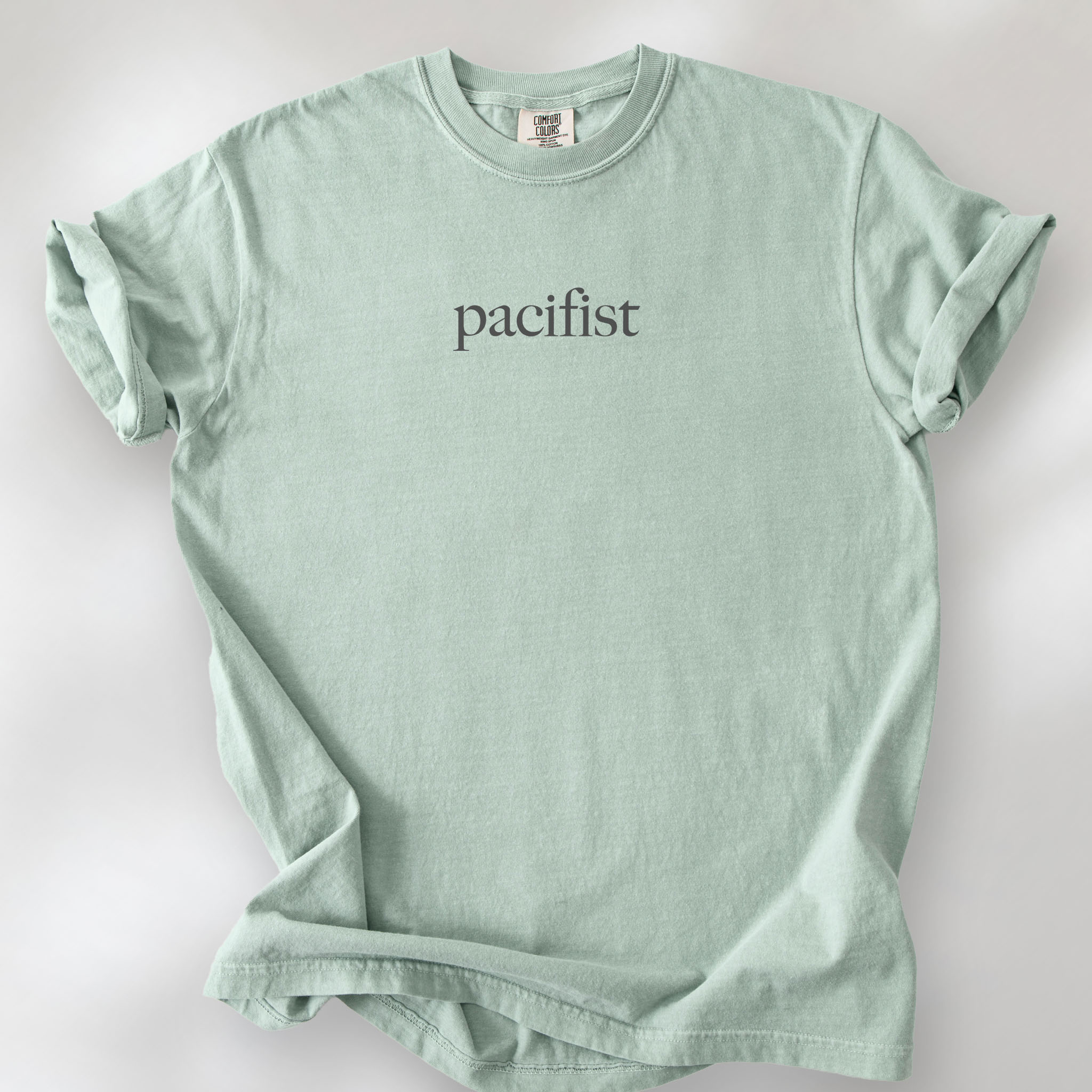 Bay t-shirt with minimalist serif text reading "pacifist."