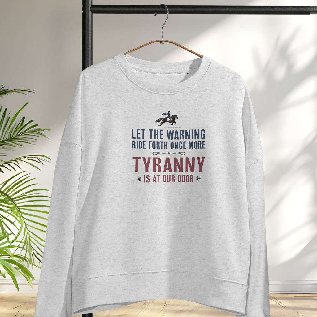 Grey sweatshirt with a silhouette of Paul Revere on horseback and the text “Let the warning ride forth once more – Tyranny is at our door” in blue and red, hanging on a hanger.