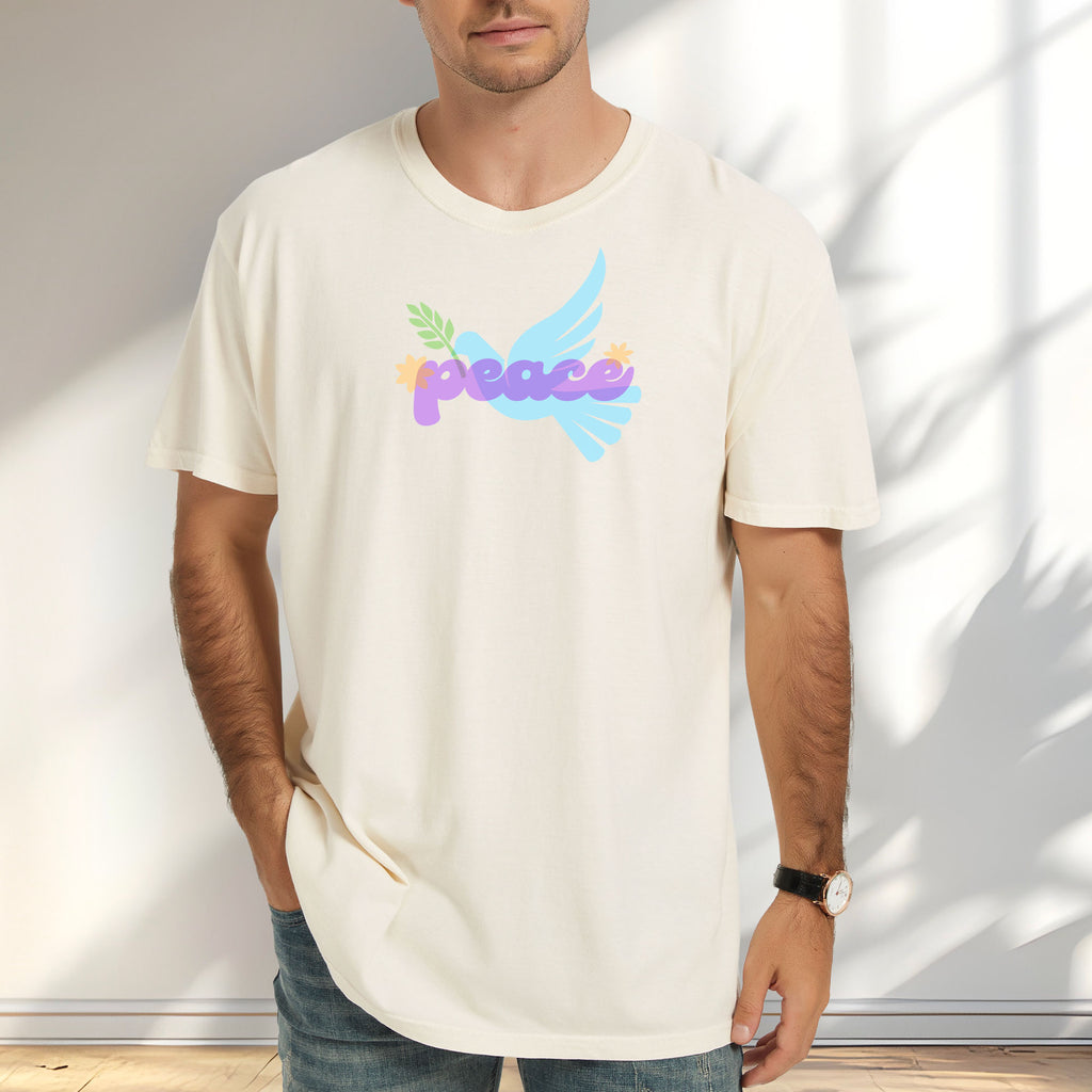 Male model wearing ivory t-shirt featuring a colorful retro peace dove carrying an olive branch with the word "peace" in groovy 1970s-style lettering. 