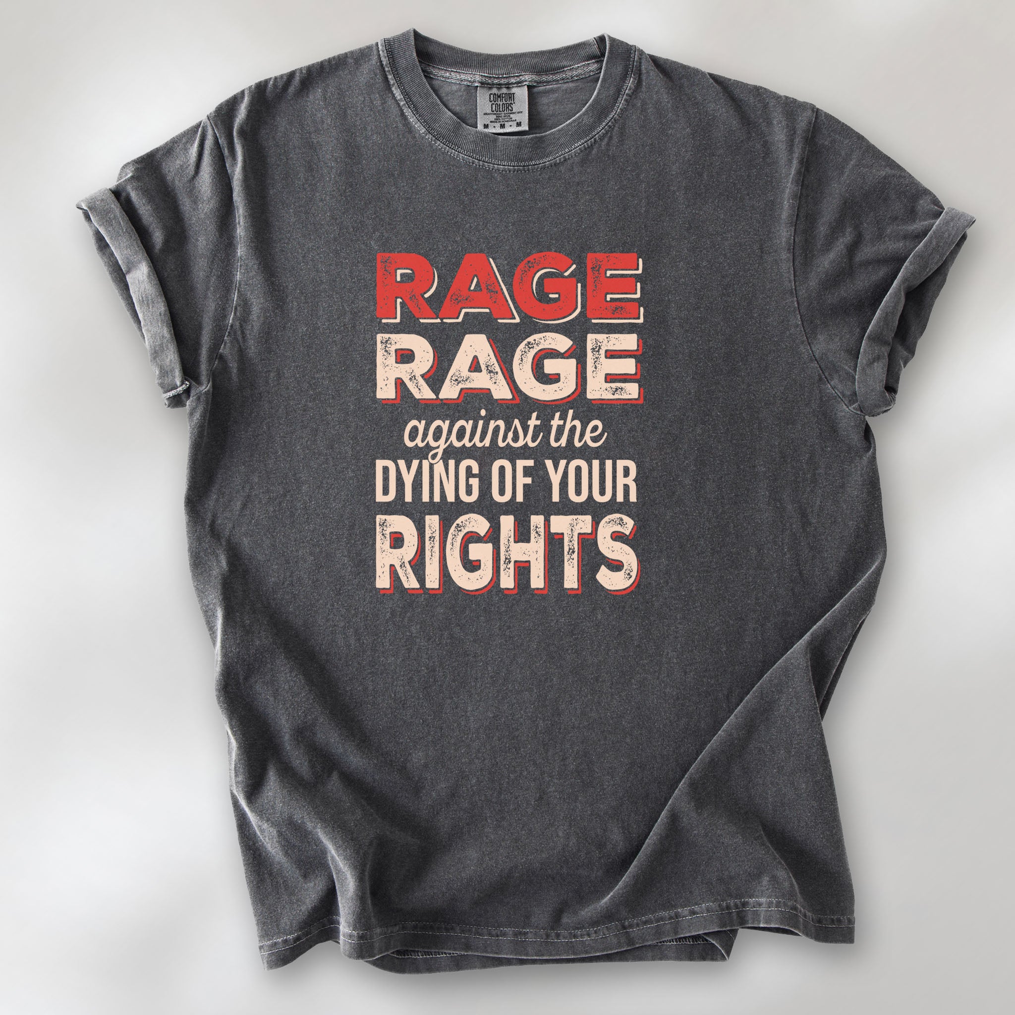 Pepper unisex Comfort Colors 1717 t-shirt with bold distressed text that reads “RAGE RAGE against the DYING OF YOUR RIGHTS” in red and cream—political protest shirt for liberals and activists.