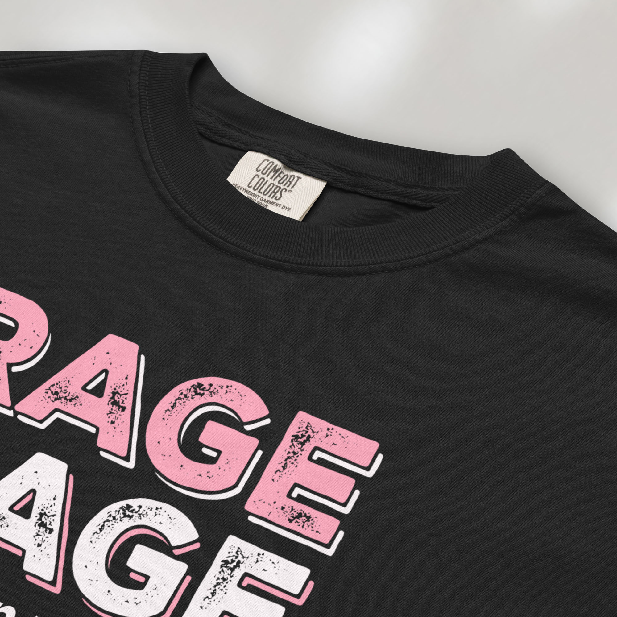 Closeup detail of black t-shirt with distressed bold text that reads "rage rage against the dying of your rights".