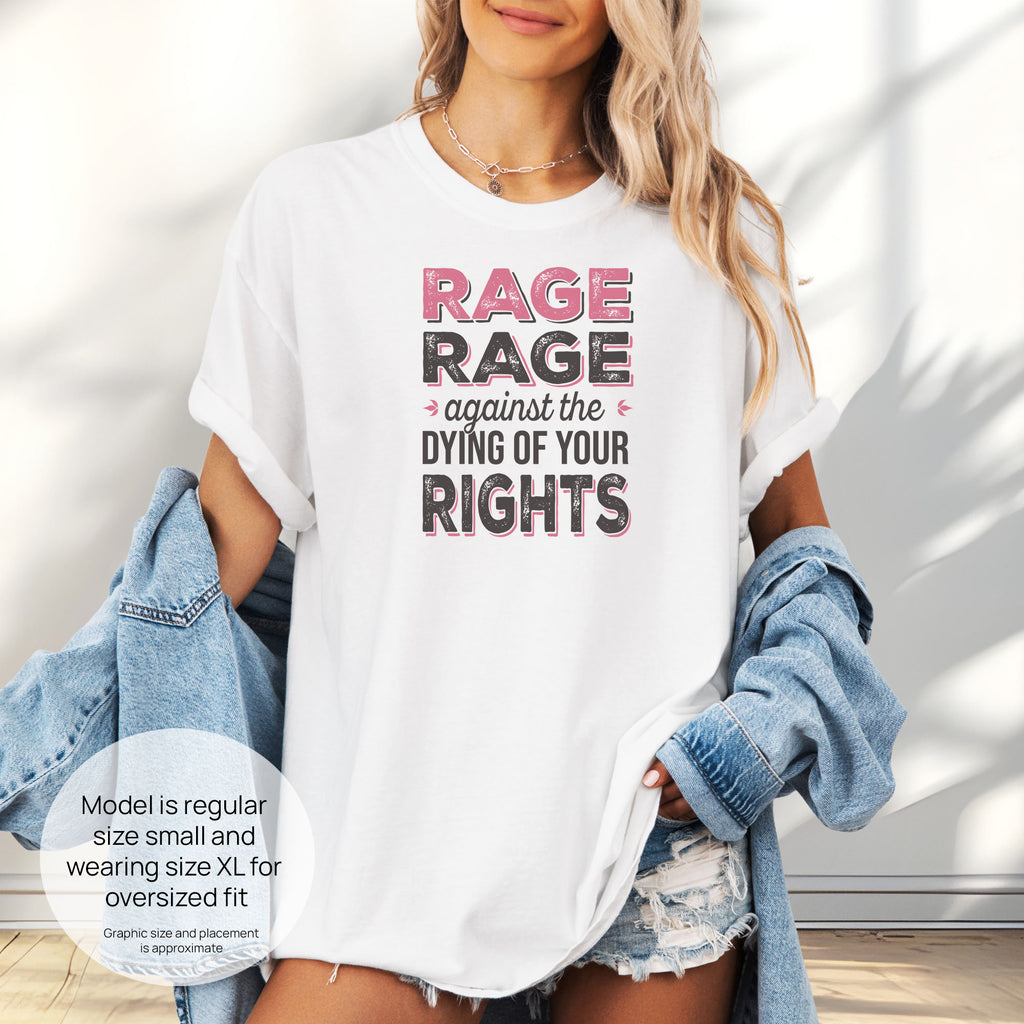 Female model wearing oversized white t-shirt with distressed bold text that reads "rage rage against the dying of your rights". Includes size and fit information for the model who is regular size small, and wearing a size XL shirt for an oversized fit.
