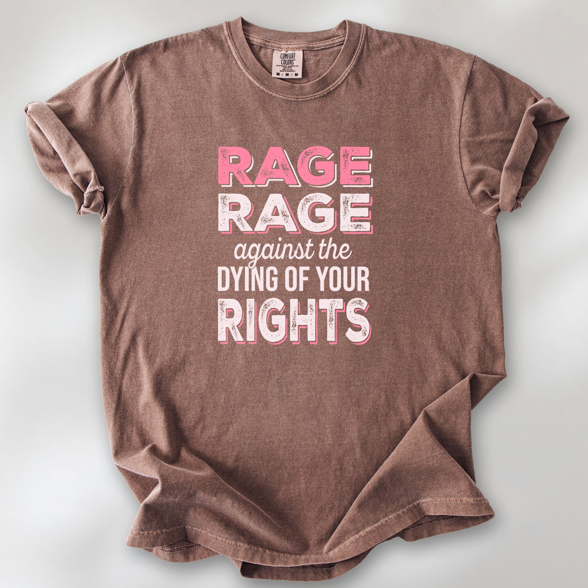 Espresso protest t-shirt with bold pink and white text reading “rage rage against the dying of your rights” – feminist anti-trump activist shirt.