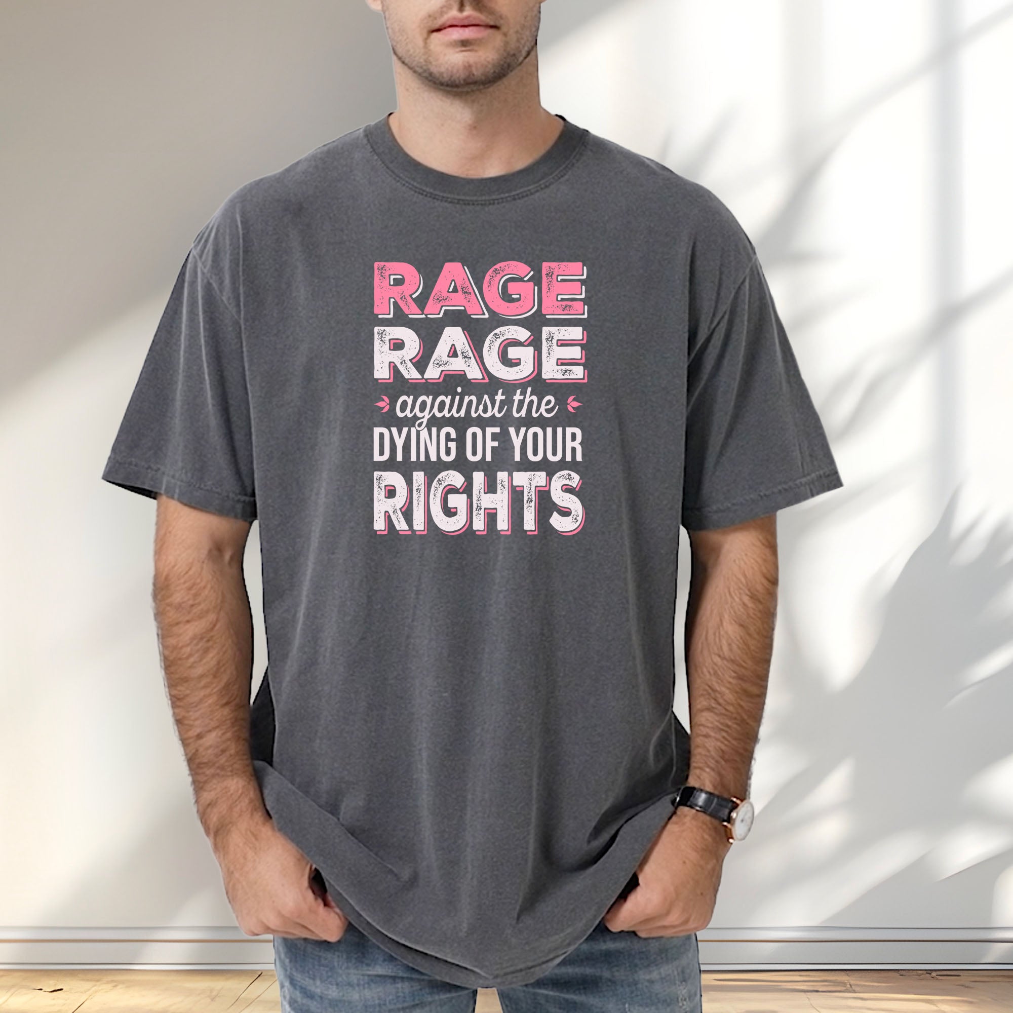 Male model wearing pepper t-shirt with distressed bold text that reads "rage rage against the dying of your rights".