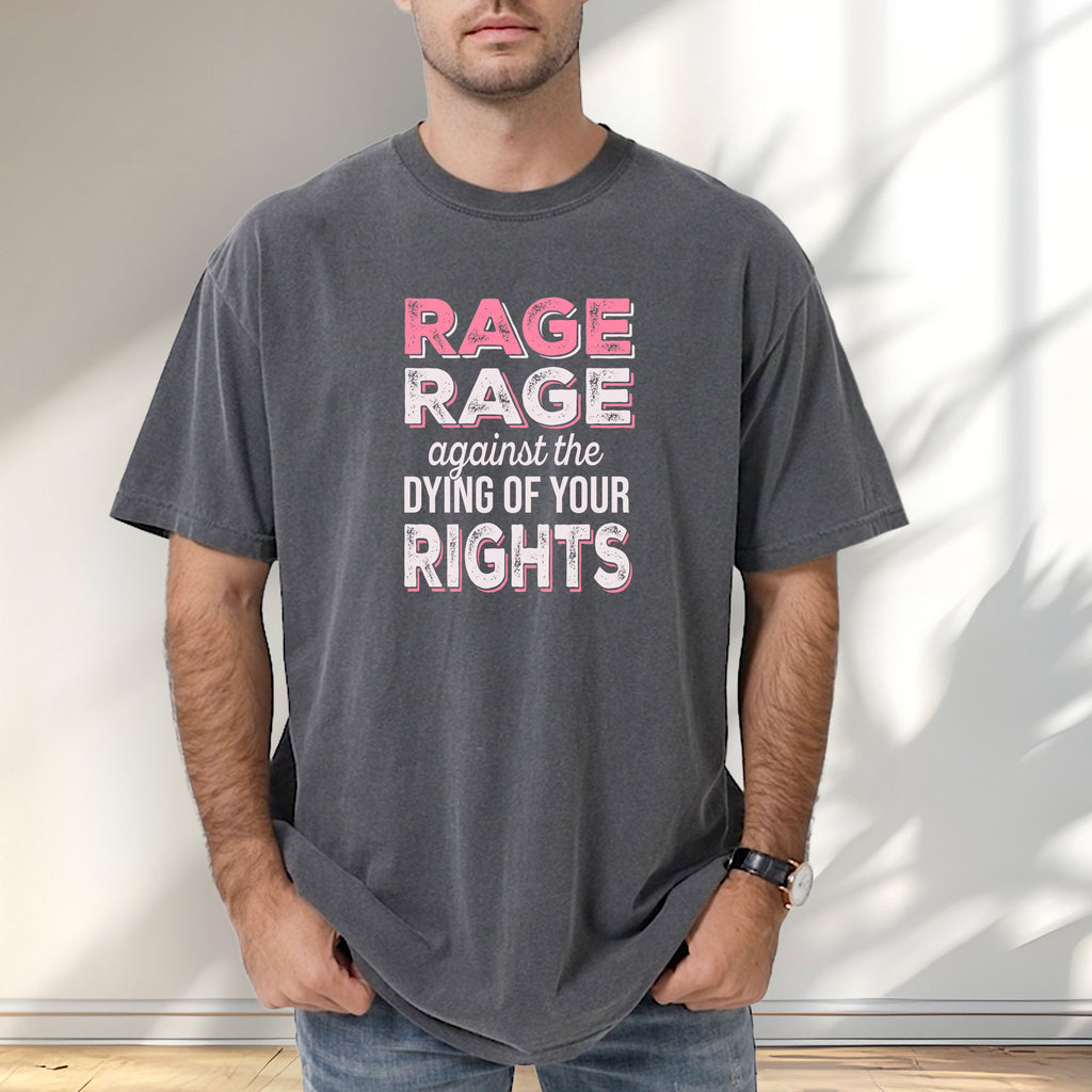 Male model wearing pepper protest t-shirt with bold pink and white text reading “rage rage against the dying of your rights” – feminist anti-trump activist shirt.