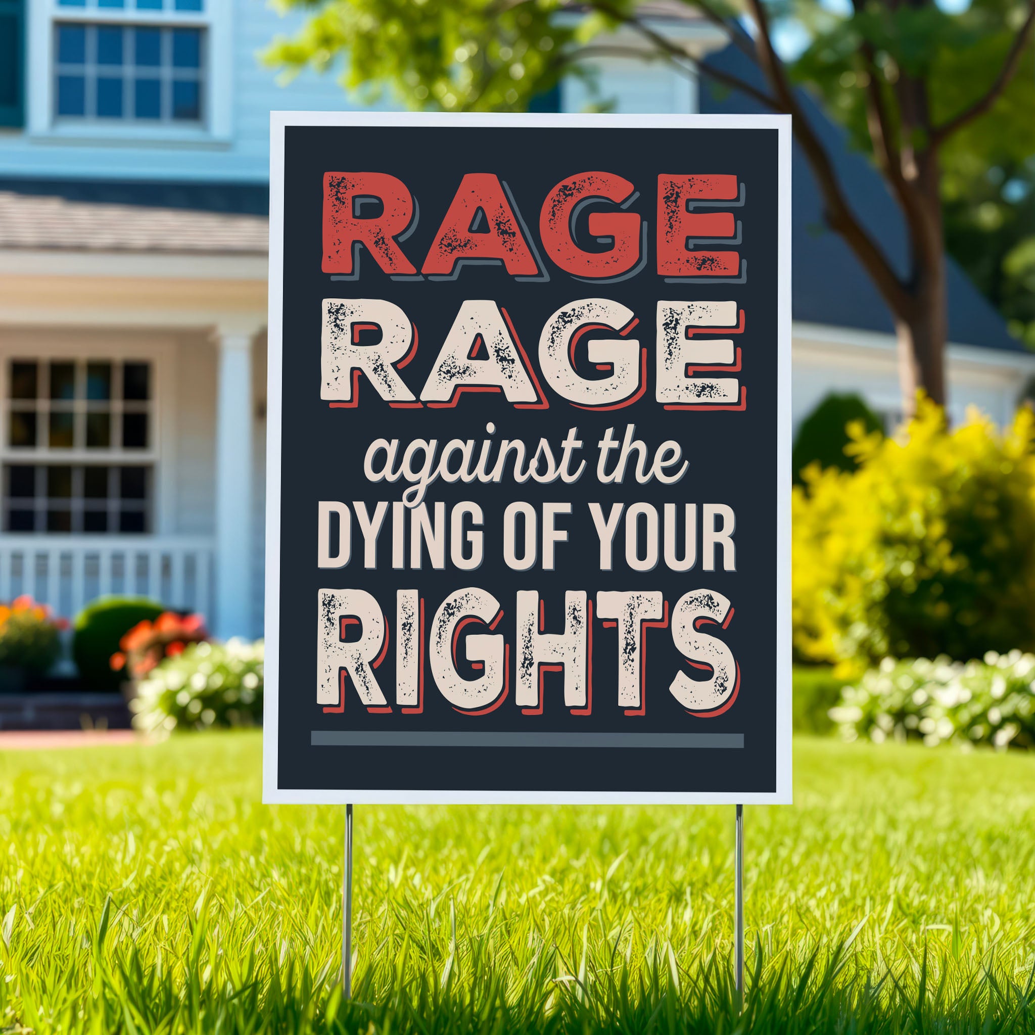 Yard sign with bold distressed text that reads "Rage rage against the dying of your rights," a political twist to the line from a Dylan Thomas poem, planted in a green lawn.