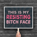 Downloadable, printable anti-trump protest sign with a black background and pink distressed text that reads "This is my resisting bitch face" in all uppercase letters.