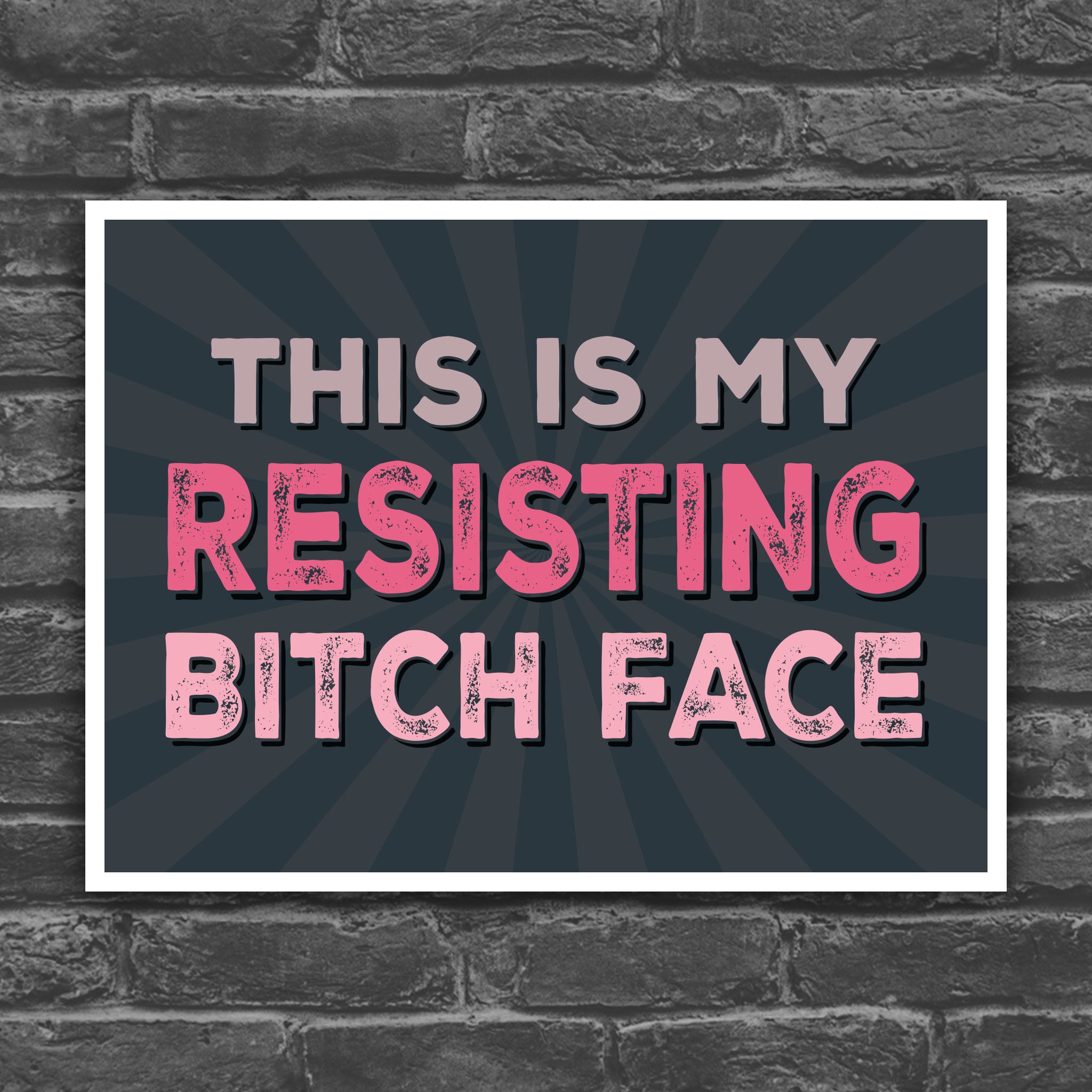 Color version of protest sign with distressed text that reads "This is my resisting bitch face" in all uppercase letters.