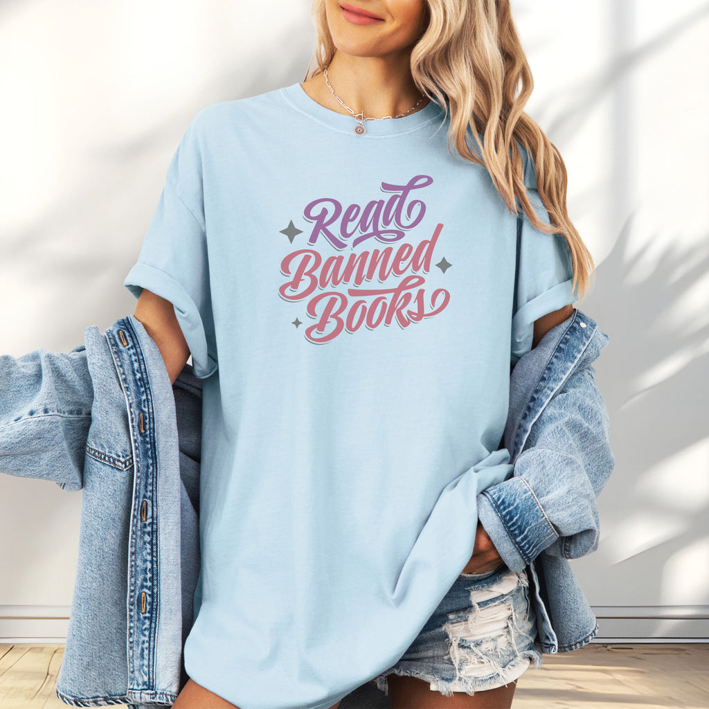 Female model wearing oversized chambray t-shirt with stylized text reading “Read Banned Books” in bold script lettering.
