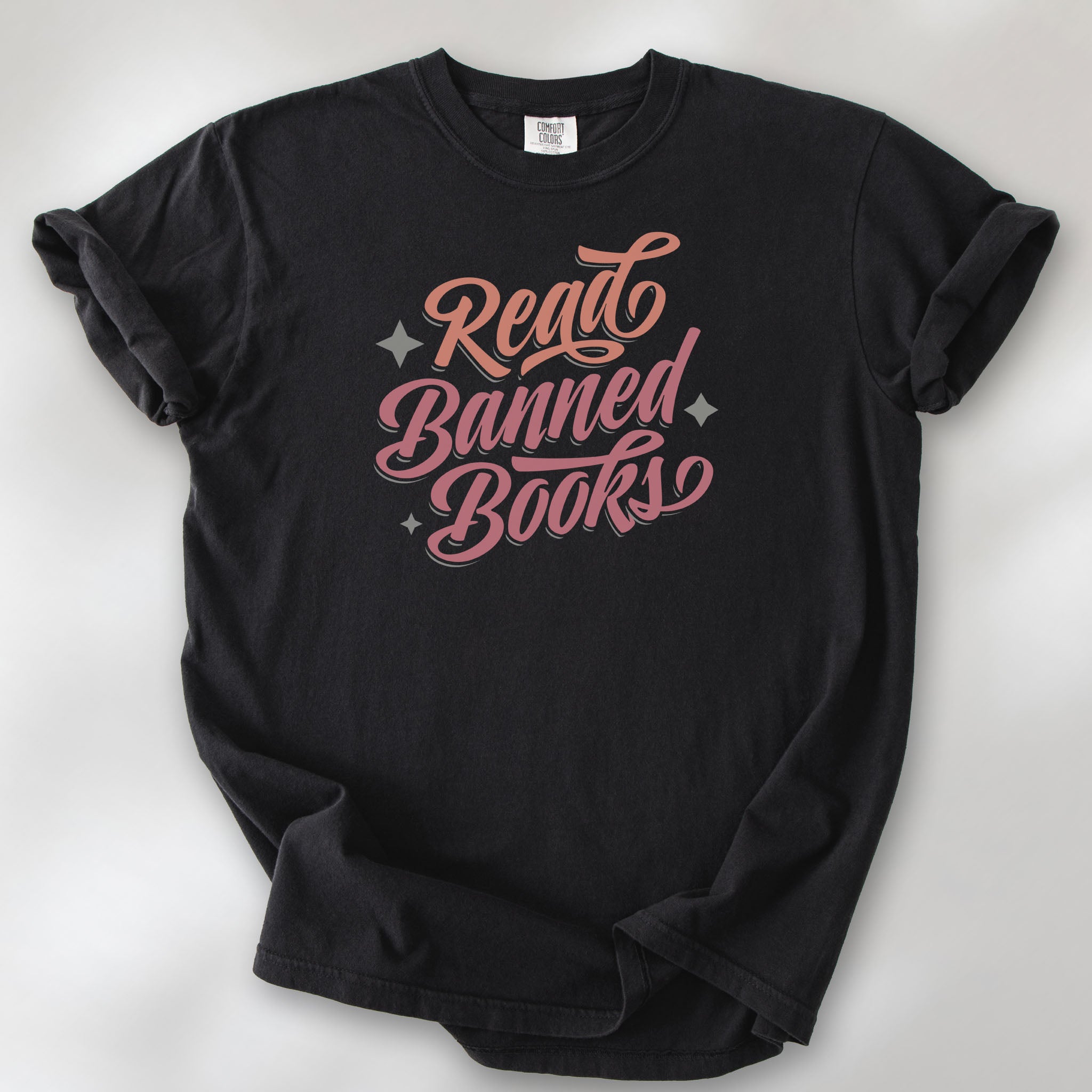 Black t-shirt with stylized text reading “Read Banned Books” in bold script lettering.