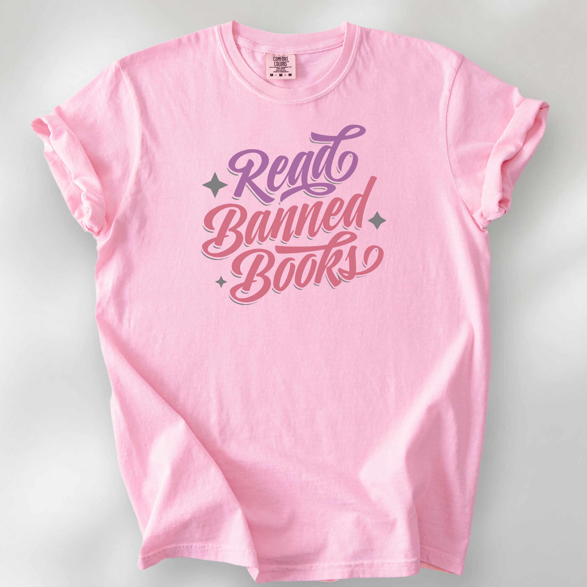 Blossom t-shirt with stylized text reading “Read Banned Books” in bold script lettering.
