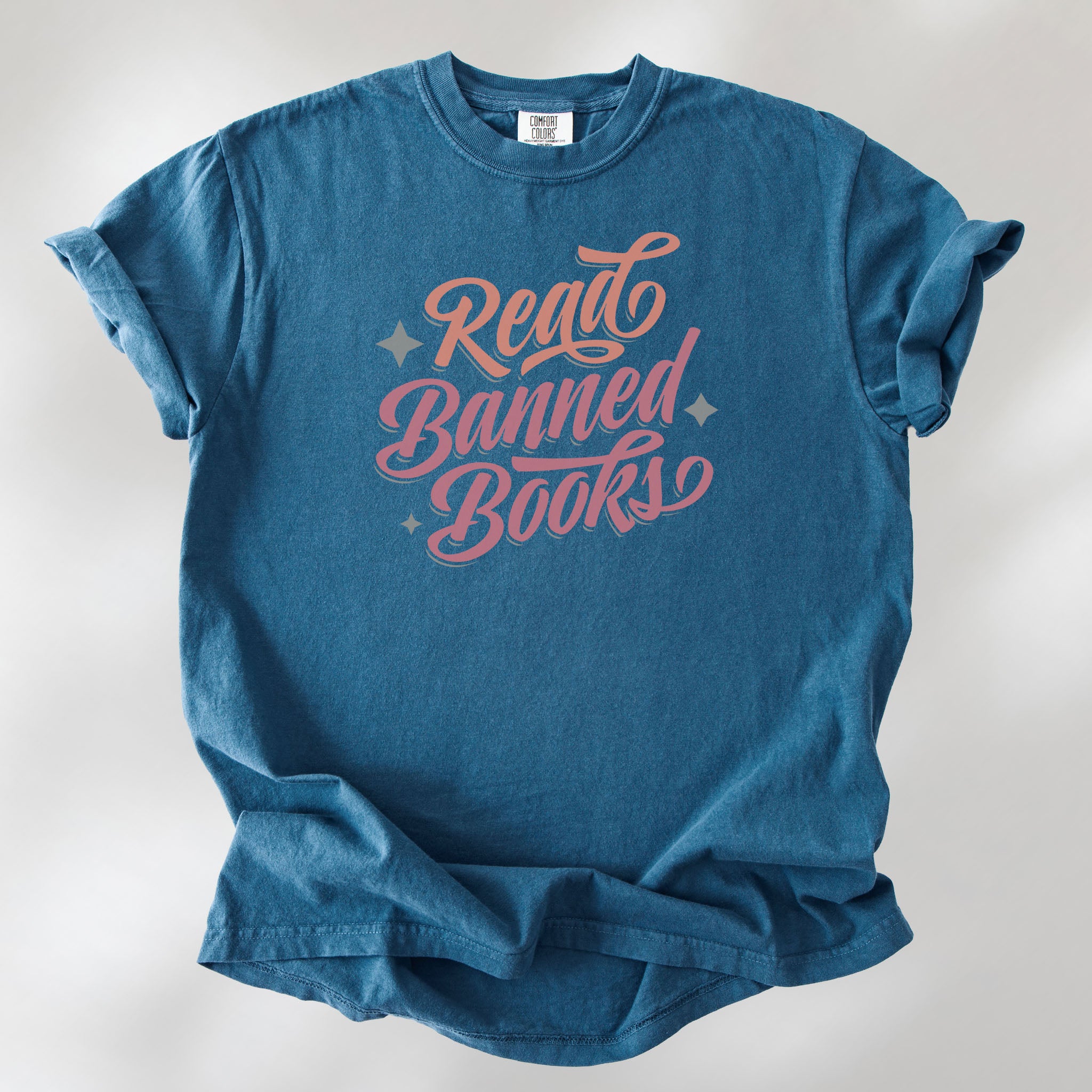 Midnight t-shirt with stylized text reading “Read Banned Books” in bold script lettering.