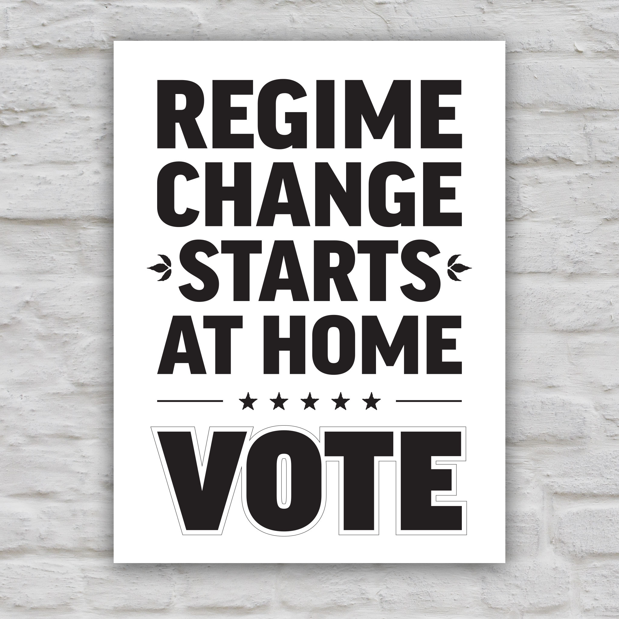 Black and white version of protest sign reading “Regime Change Starts at Home — Vote” in red and blue political typography.