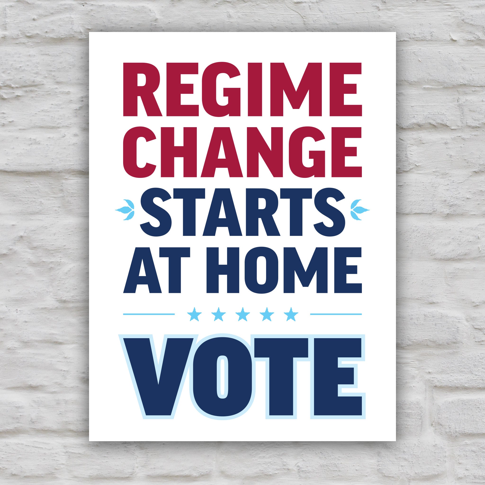 Color version of protest sign reading “Regime Change Starts at Home — Vote” in red and blue political typography.