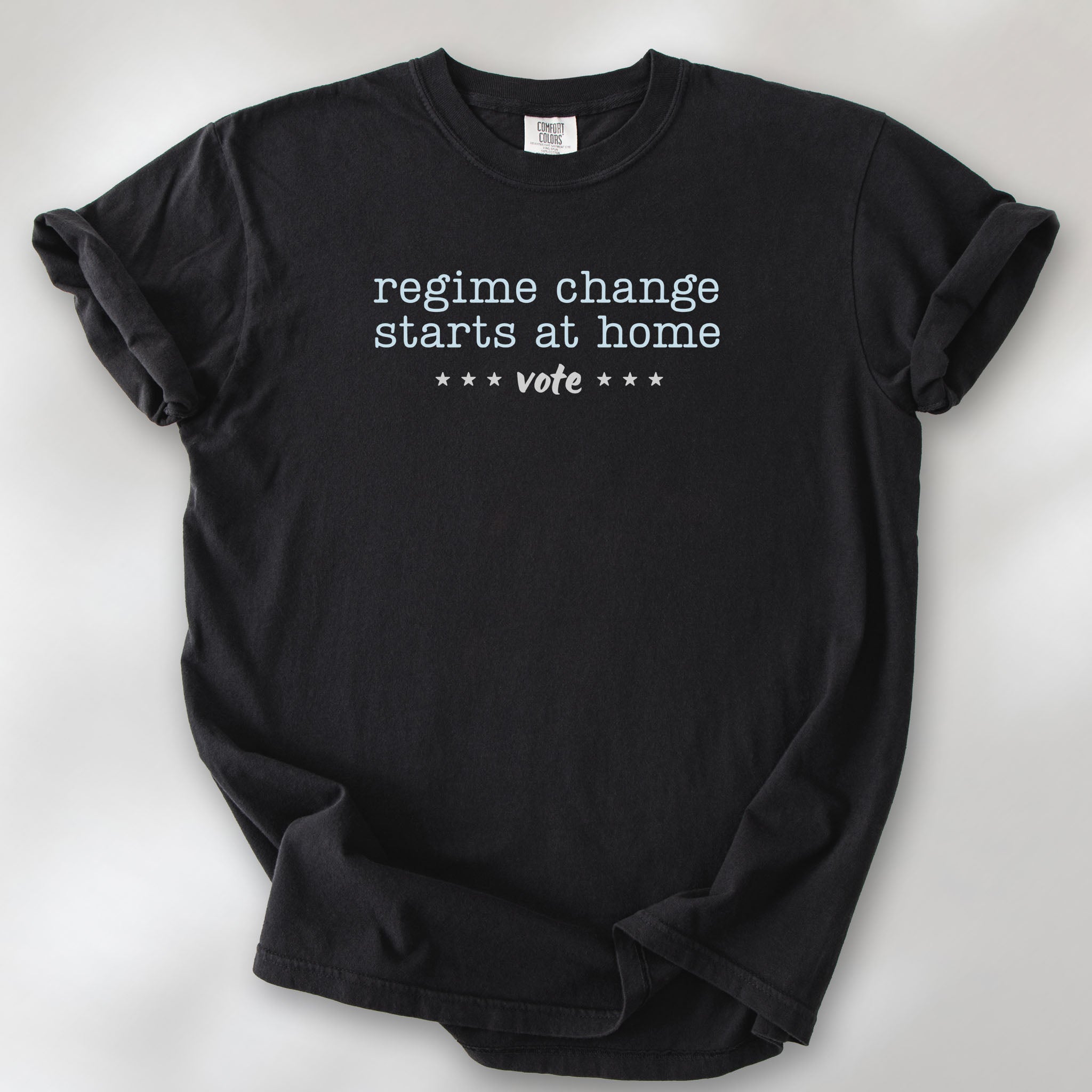 Black t-shirt with text that reads "regime change starts at home – vote."
