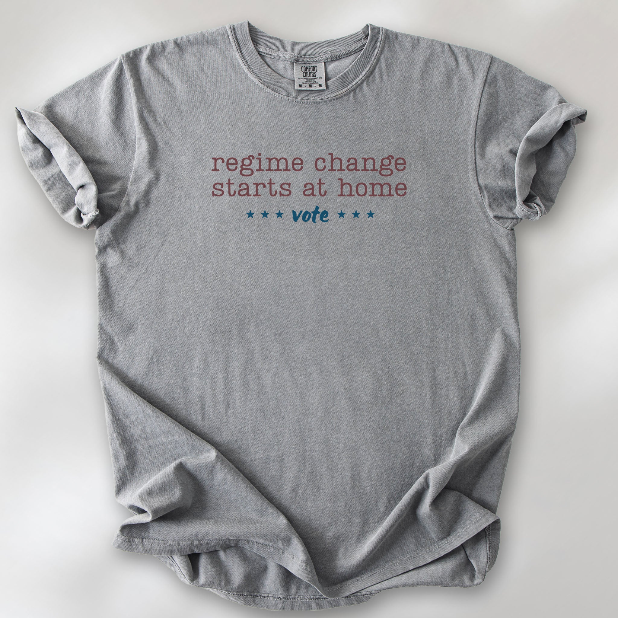 Grey t-shirt with text that reads "regime change starts at home – vote."