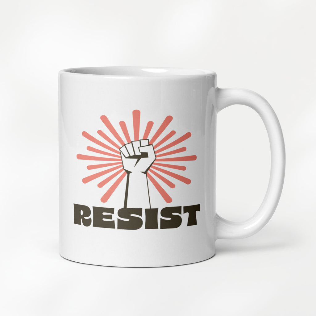 11 ounce ceramic mug with a raised fist graphic in front of a coral burst, and bold retro-styled text that says "resist."