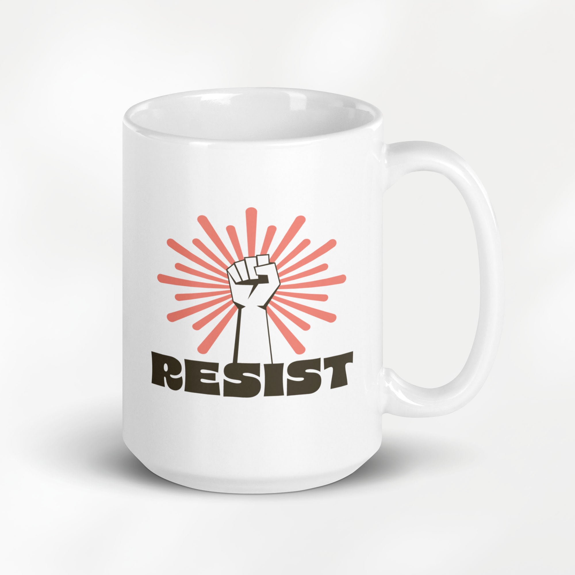 15 ounce ceramic mug with a raised fist graphic in front of a coral burst, and bold retro-styled text that says "resist."