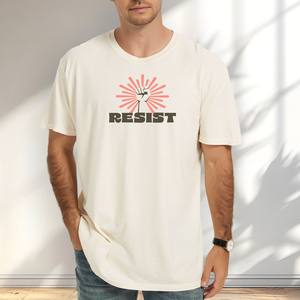 Male model wearing ivory t-shirt with retro style "resist" text, raised fist, and pinkish burst behind the fist.