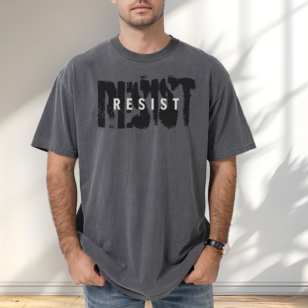 Male model wearing pepper t-shirt with the word "resist" atop the word "resist" in a grunge background texture.