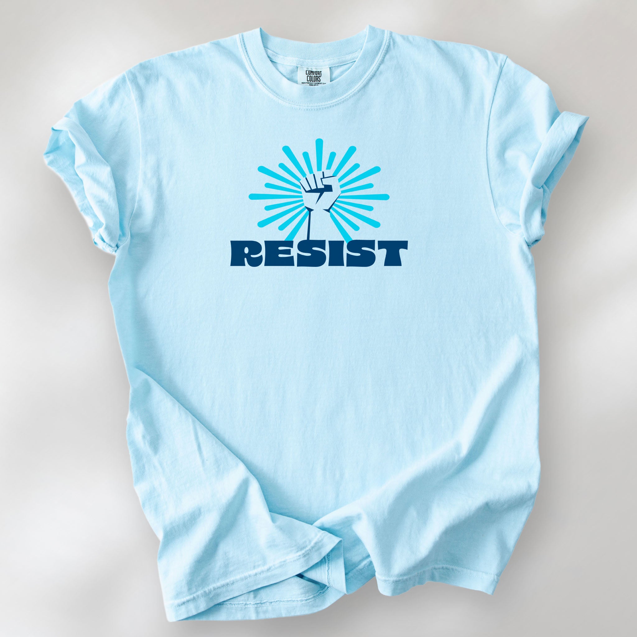 Chambray t-shirt with blue Minnesota-themed “Resist” retro text and stylized raised fist design with burst.