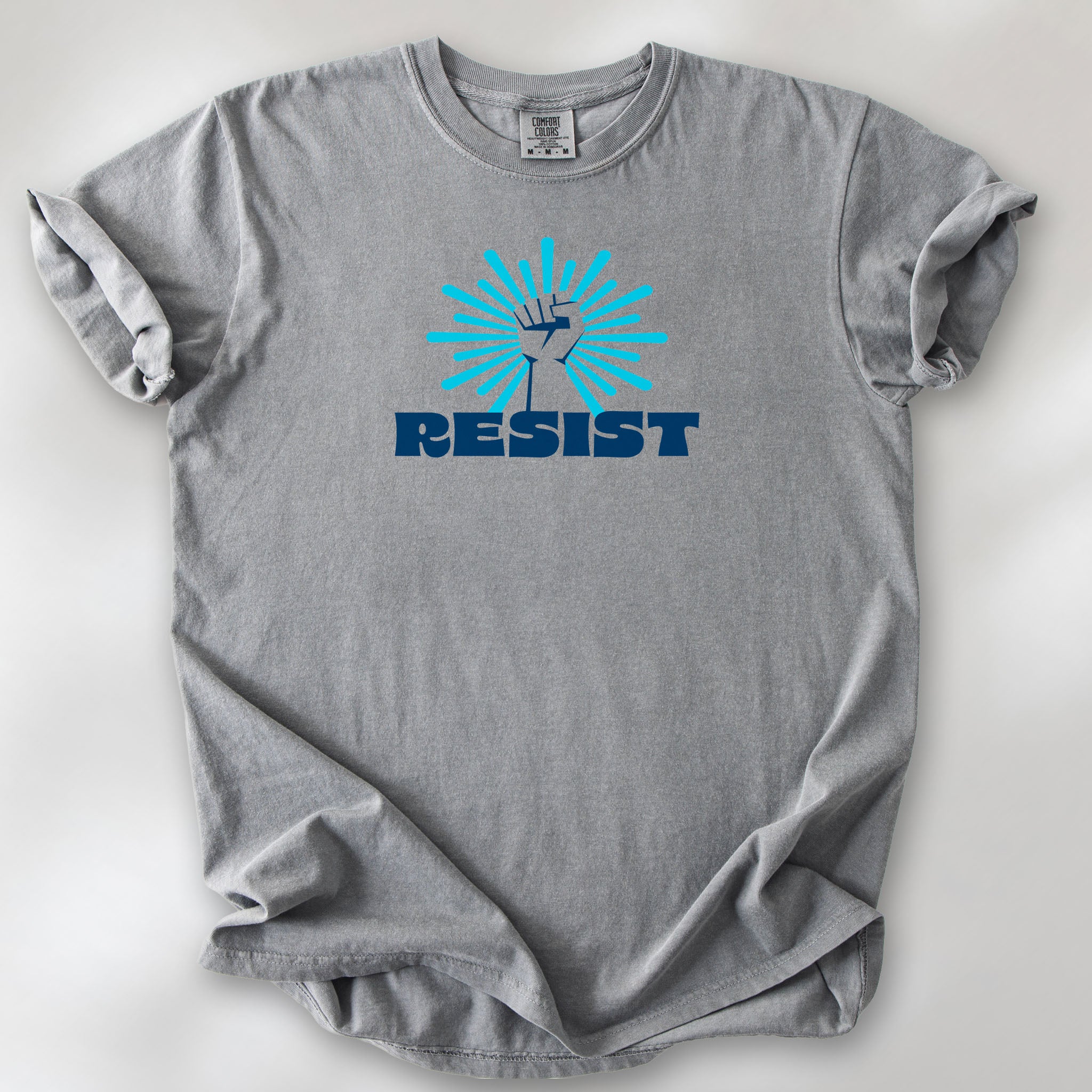 Grey t-shirt with blue Minnesota-themed “Resist” retro text and stylized raised fist design with burst.