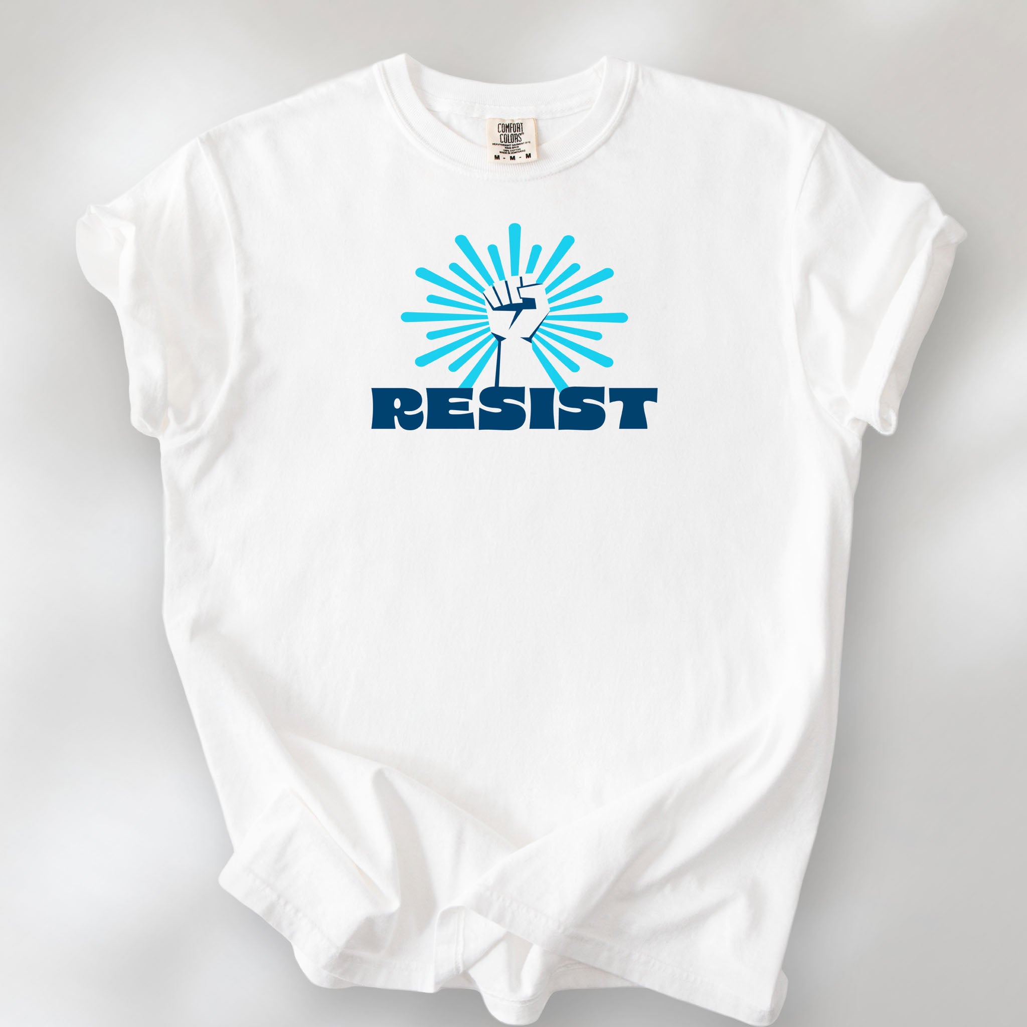 White t-shirt with blue Minnesota-themed “Resist” retro text and stylized raised fist design with burst.