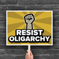 Protest sign with raised fist and bold text that says “Resist Oligarchy.” Political activist sign for rallies, marches, and progressive protests.
