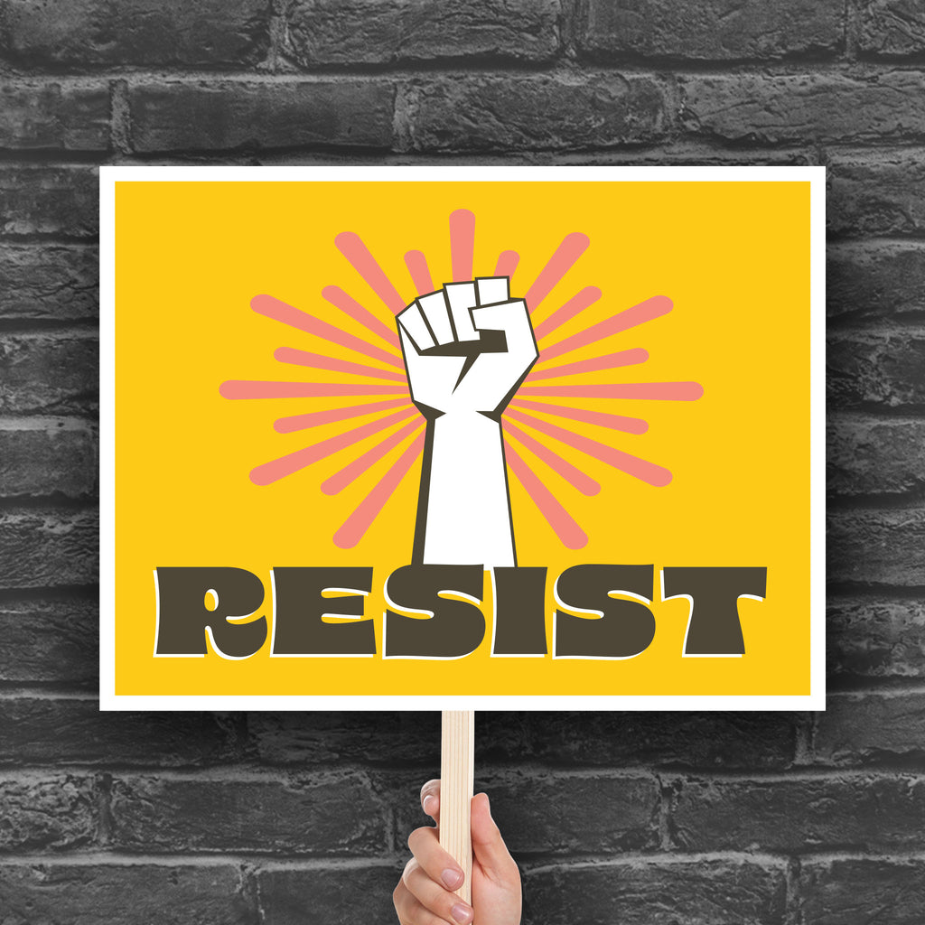 Printable protest sign with a white raised fist and the word “resist” in bold brown letters on a bright yellow background with pink radiating lines.