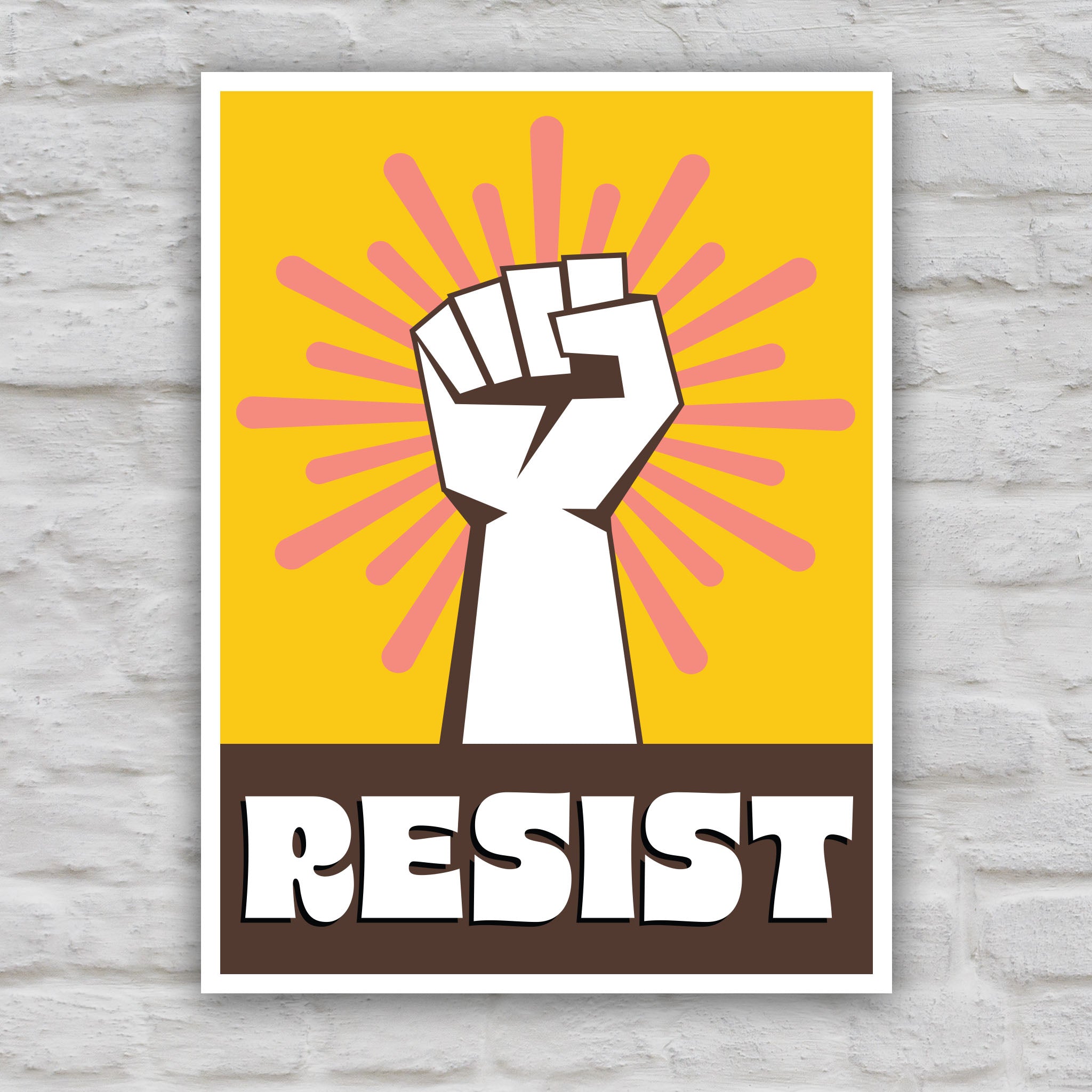 Color version of protest sign with yellow background behind a white raised fist and pink burst, with the retro-styled bold word "resist" below, reversed out of brown.