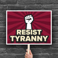 Red color version of downloadable, printable anti-Trump protest sign with bold text that reads "resist tyranny" below a raised fist.