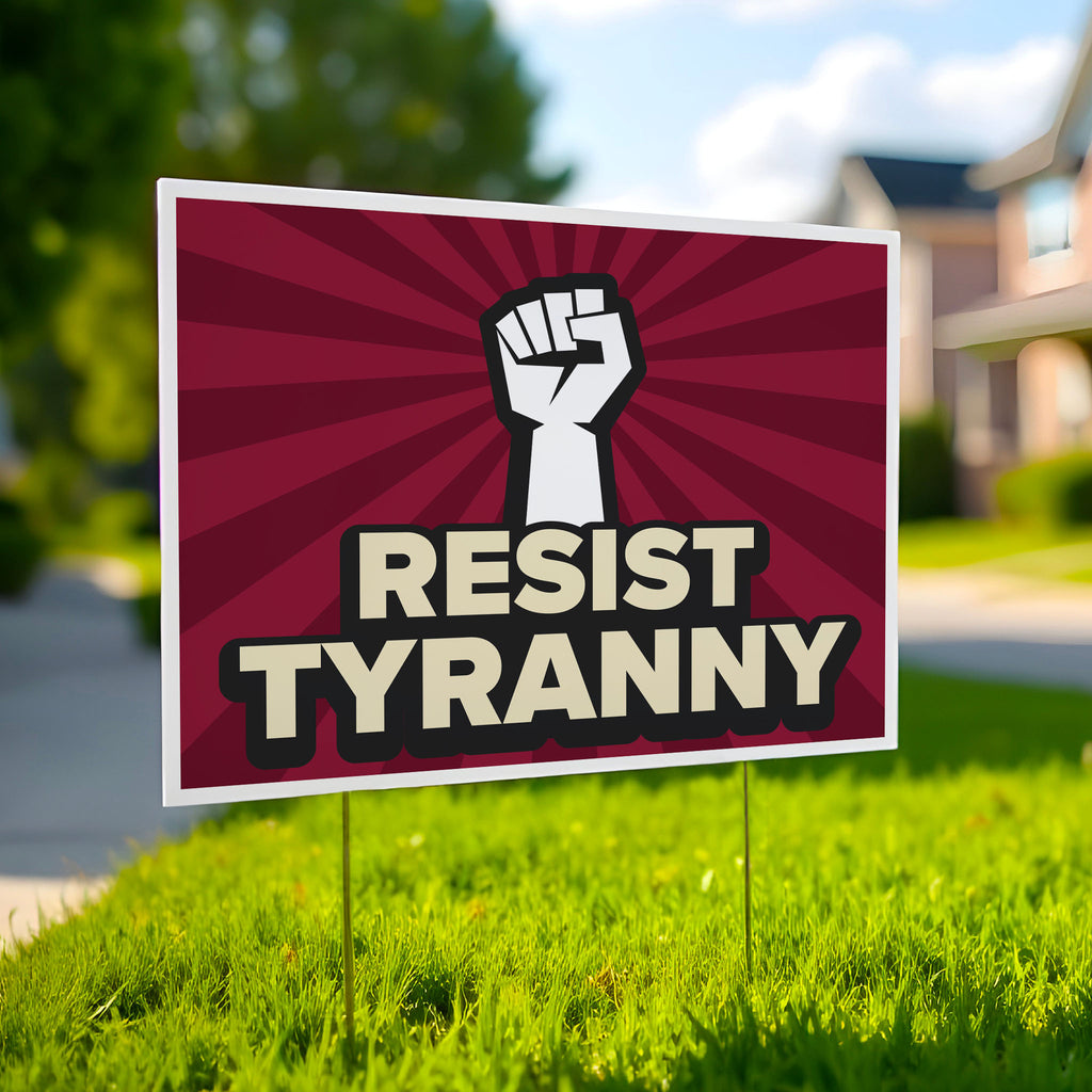 Red color version of yard sign with bold text that reads "resist tyranny" below a raised fist, planted in a green lawn.