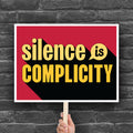 Downloadable, printable protest sign with yellow text that reads "silence is complicity" on a red background.