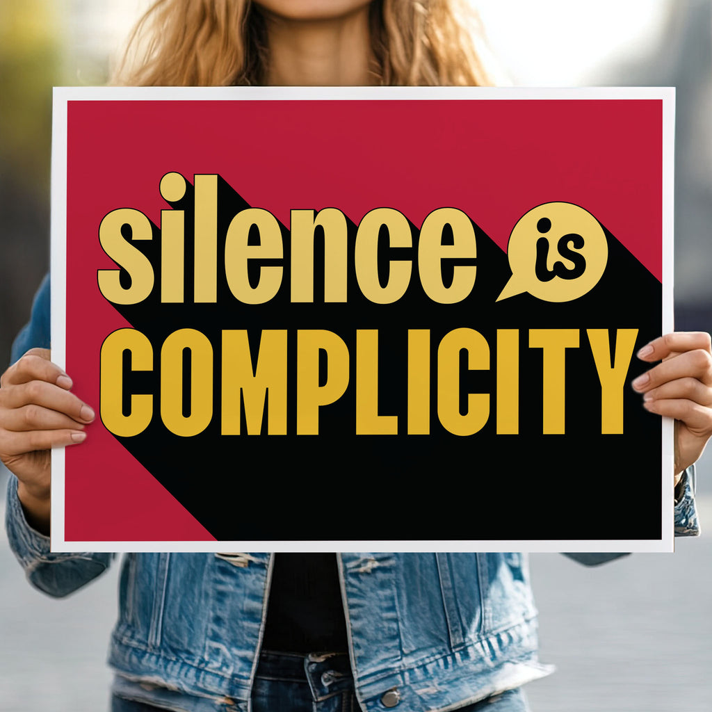 Person holding protest sign with yellow text that reads "silence is complicity" on a red background.