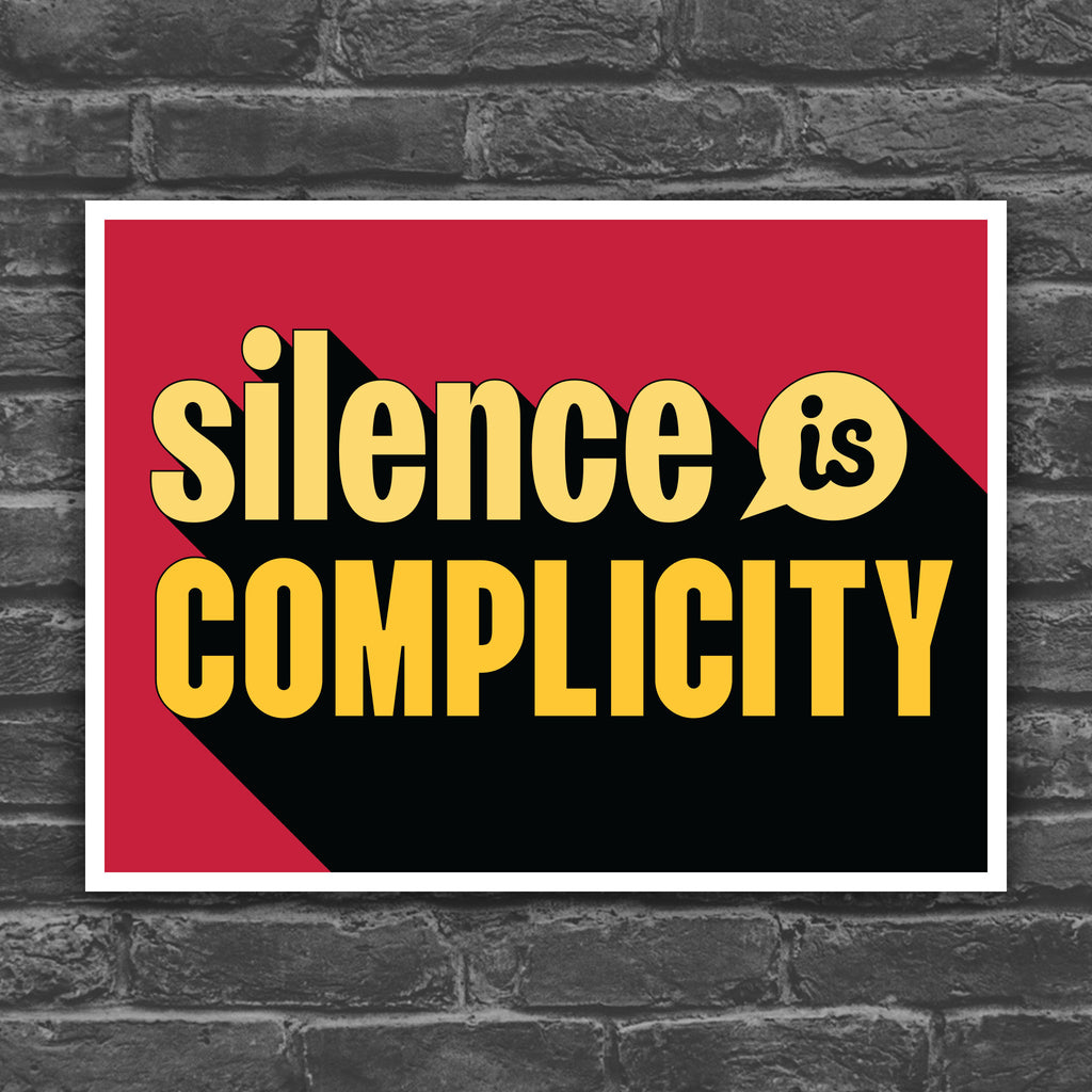 Color version of protest sign with yellow text that reads "silence is complicity" on a red background.