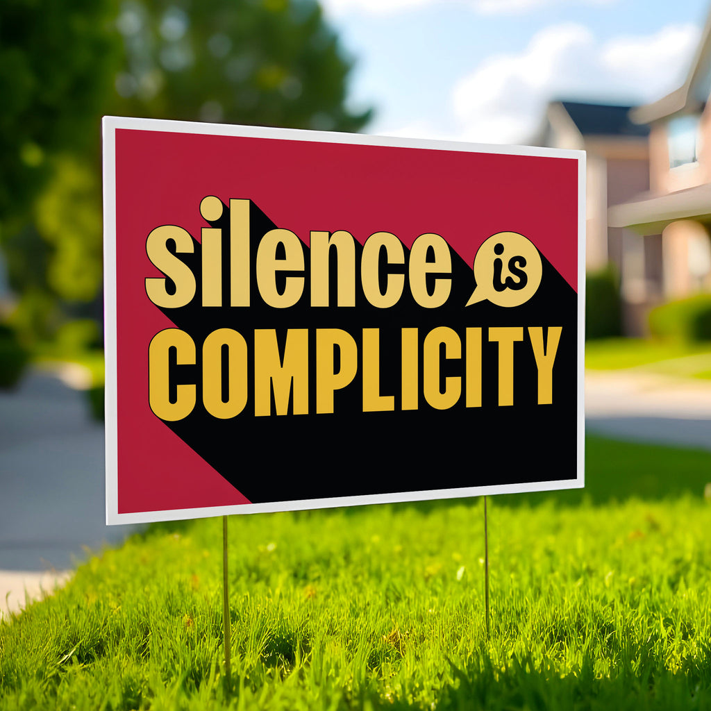 Yard sign with yellow text that reads "silence is complicity" on a red background.