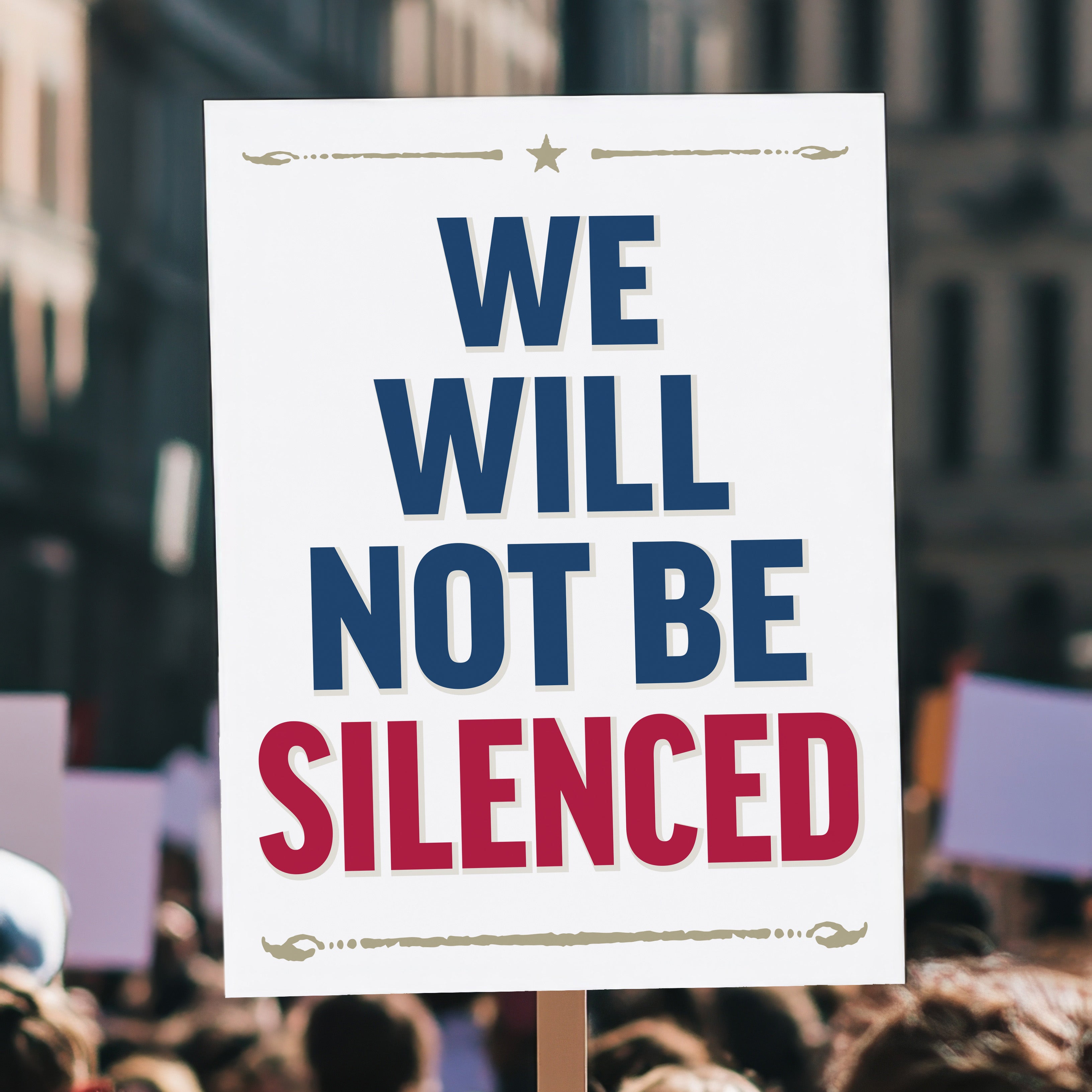 Protest sign held high above a crowd, with bold red and blue text reading “We Will Not Be Silenced,” perfect for anti-Trump rallies defending free speech and constitutional rights.