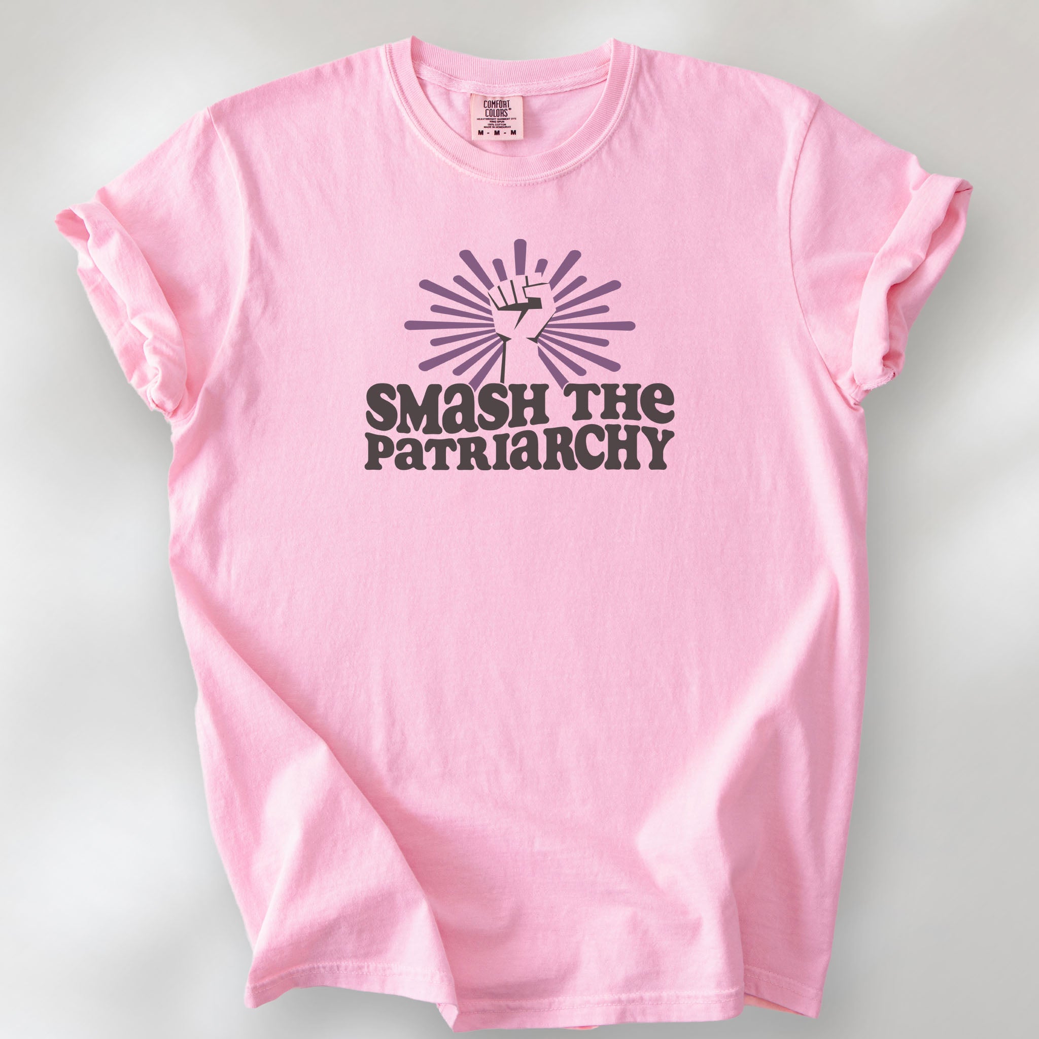 Blossom t-shirt with a raised fist graphic and purple burst above the text “Smash the Patriarchy.”
