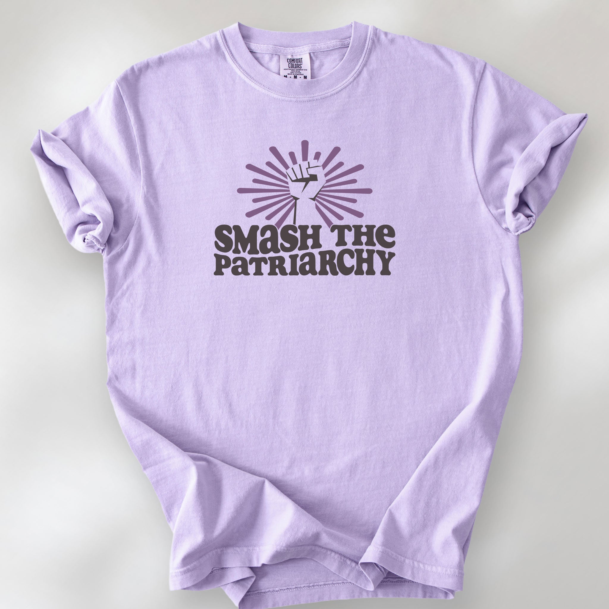 Orchid t-shirt with a raised fist graphic and purple burst above the text “Smash the Patriarchy.”