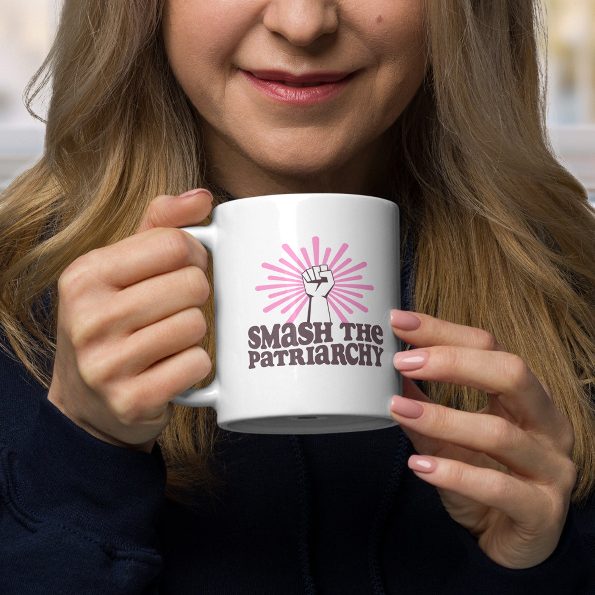 Woman holding coffee mug that says 