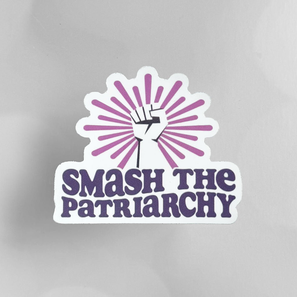 Die-cut vinyl sticker featuring a raised fist with a pink sunburst above the words "Smash the Patriarchy".